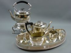 A three piece electroplated tea service, each piece of oval reeded form together with a near