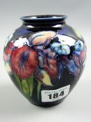 A Moorcroft Columbine deep blue ground vase, impressed factory marks to the base, 11 cms high