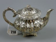 A finely decorated and finely marked circular silver bachelor teapot with raised floral decoration