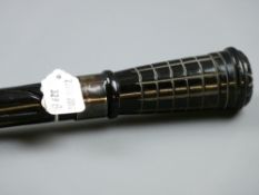 A carved ebony walking cane with hallmarked silver band and carved horn grip having a starcut top,