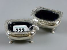 Pair of hallmarked Chester 1907 silver salts with pierced foliate rim and blue glass liners on