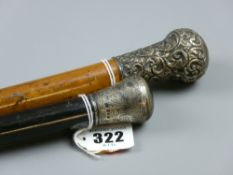 An ebony hallmarked silver topped walking cane and an embossed hallmarked silver topped walking cane