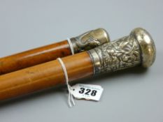 Two malacca walking canes with white metal grips (possibly Chinese silver) embossed Chinese dragon