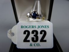 An unmarked gold dress ring having a centre oval sapphire with two tiny round cut flanking diamonds,