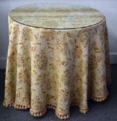 A circular glass topped occasional table (from Derry & Toms Department store, Kensington High