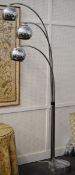 A designer chrome three branch standard lamp on a veined grey marble circular base
