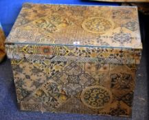 A vintage Japanese tea chest covered in decorative floral and geometric design paper