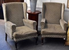 A pair of vintage wing back chairs