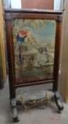 A Victorian rosewood firescreen with pictorial sampler panel and padded footrest on sweeping