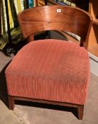 A matching set of three chairs with curved wooden backs and deep cushioned seats