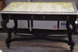 A rectangular two drawer ebonised side table on four sweeping corner supports and shaped x-stretcher