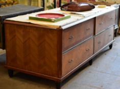 A four drawer department store cabinet composed of two pairs of side by side drawers with metallic