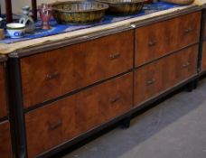 A four drawer department store cabinet composed of two pairs of side by side drawers with metallic