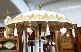 A set of four reproduction colonial elephant umbrellas on concrete plinths