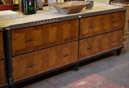 A four drawer department store cabinet composed of two pairs of side by side drawers with metallic