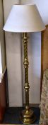 A brass/brassed twist column circular based standard lamp and shade