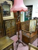 An early 20th Century carved wooden standard lamp and shade