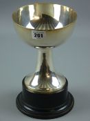 A plain silver wide trophy cup on a shaped plain plinth and circular base, 17 cms high, 16 troy ozs,