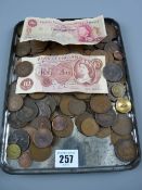 A large parcel of British bronze coinage, a ten shilling British bank note and a ten shilling Isle