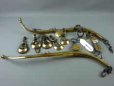 A pair of antique polished brass horse hames with iron fittings with a quantity of horse brasses