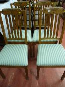 A set of four polished 1930's dining chairs with fan and bell carving to the top rails and five