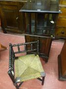 An Edwardian side cabinet with revolving bookcase top and single drop down front cupboard door on