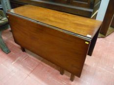 A Georgian mahogany drop leaf dining table on square chamfered corner supports, approximately 140