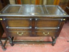 A Jacobean style oak lidded mule chest with two frieze drawers on barley twist legs with turned