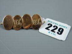 Four oval nine carat gold cufflinks, fashioned into a bar brooch, total 6.5 grms
