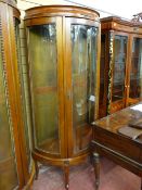 A reproduction mahogany effect demi-lune display cabinet, three bowed glass beaded edge panels