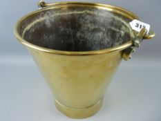 An antique brass coal bucket with swing handle, the handle loops fixed with copper rivets and marked