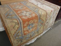 Three Eastern woollen tasselled edge rugs, various colours with geometric patterns, one 192 x 125