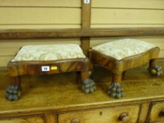 A good pair of walnut Empire style footstools, serpentine top sections on hairy paw and gilt ball