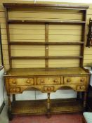 A George III oak South Wales borders dresser with open back three shelf Delft rack, full length shoe