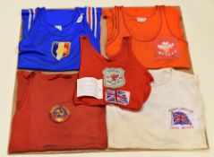 FOUR VINTAGE INTERNATIONAL GYMNASTIC VESTS & A GREAT BRITAIN 1972 T-SHIRT WITH STITCHED BADGE,