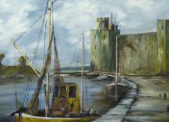 J DAVIES oil on board - Caernarfon Castle and Harbour with boats, signed and dated 1974, 44 x 74 cms