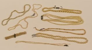 EIGHT PEARL NECKLACES, one with diamond clasp