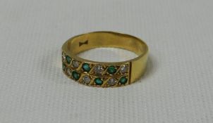 AN 18ct YELLOW GOLD EMERALD & DIAMOND RING with seven of each stone in two alternate rows, 3.8gms
