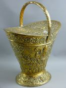 A repousse brass twin lidded helmet shaped coal bucket, 53 x 44 cms
