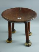 A carved tribal stool, South West Kenya, probably Kipsigis, a dished form African four legged