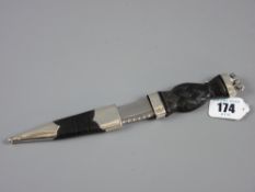 A miniature dirk having an ebonized or bog oak basket woven shaped handle with silver lion atop
