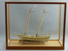 A 20th Century glass cased model of a boat with interior brass plate marked 'Virginia Pilot, Circa