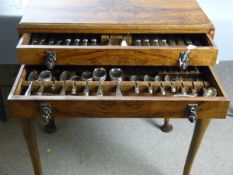 A WALNUT TWO DRAWER CANTEEN TABLE, one hundred plus pieces of electroplate table cutlery contained