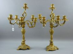 A PAIR OF FIVE BRANCH BRASS CANDELABRA, probably Continental, early 20th Century in heavy Rococo
