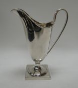A CASED SILVER HELMET CREAM JUG, of plain form, London 1956, 3.1ozs