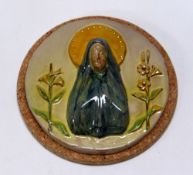 A WILLIAM FISHLEY HOLLAND STUDIO POTTERY RELIGIOUS PLAQUE in circular form with the Virgin Mary in