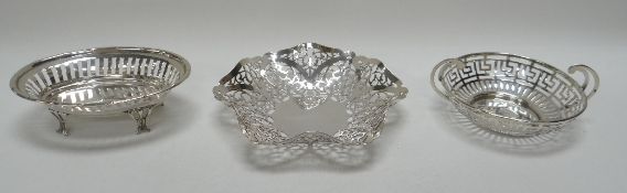 THREE DELICATE SILVER BON-BON BASKETS comprising a Grecian-key design, a raised oval example and a