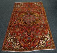 RED GROUND PERSIAN HERIZ RUG, 168 x 292cms