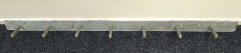 An antique painted pine coat rack