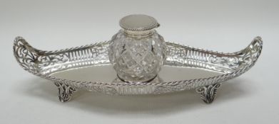 A SILVER GONDOLA-SHAPED INKSTAND having a pierce-work gallery on four pierced foliate feet and